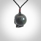 This picture shows a medium sized Black Obsidian stone skull pendant that we have hand carved. It is polished to a soft shine and is a very striking piece. Provided with an adjustable black cord.